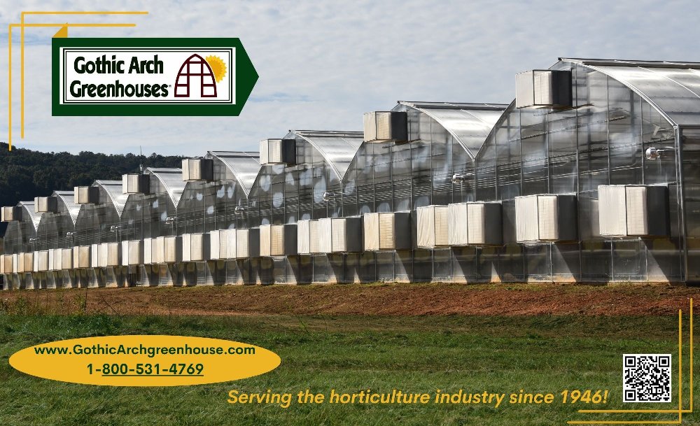 Aerial view of multiple commercial greenhouses arranged across a farm field